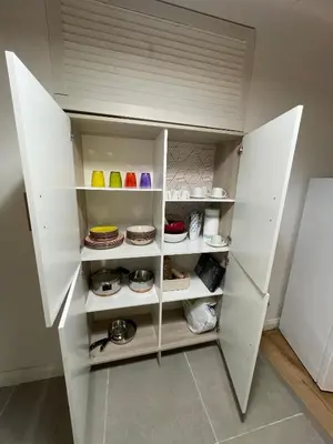 a white refrigerator with its doors open in a kitchen at Vicolo Morici in Palermo