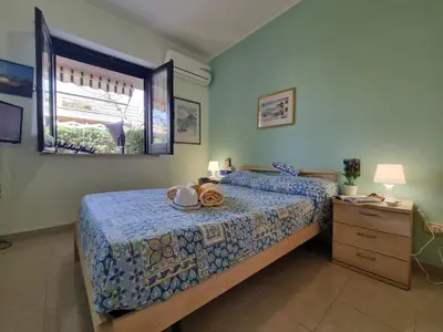 a bedroom with a bed and a dresser and a window at Respiro di Mare by Holiday World in Buonfornello