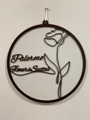 a hanging sign with a picture of a flower at Palermo Flowers Suites in Palermo