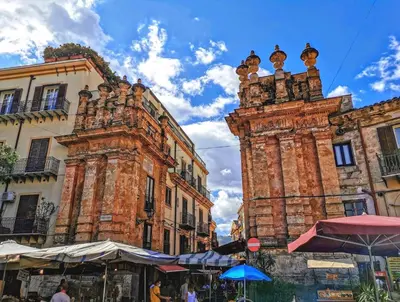 an old building with a clock tower in a city at Volturno 50 in Palermo