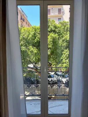 a sliding glass door with a view of a balcony at Volturno 50 in Palermo