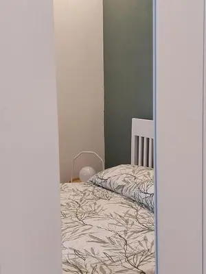 a small bedroom with a bed in a room at Volturno 50 in Palermo