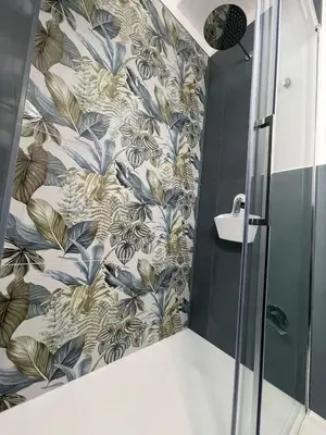 a bathroom with a shower with blue and gold wallpaper at Anfrasipe apartment in Terrasini
