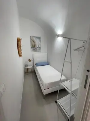 a small bedroom with a bunk bed and a ladder at Anfrasipe apartment in Terrasini
