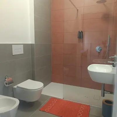 a bathroom with a toilet and a sink and a shower at Cà Porto-Rooms with Balcony&Terrace in Santa Flavia