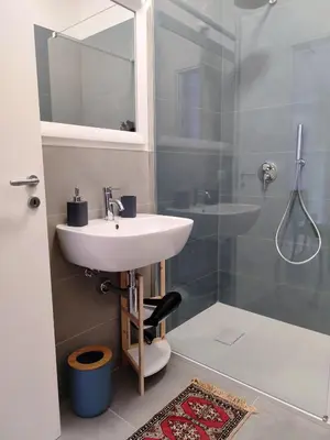a bathroom with a sink and a shower at Cà Porto-Rooms with Balcony&Terrace in Santa Flavia