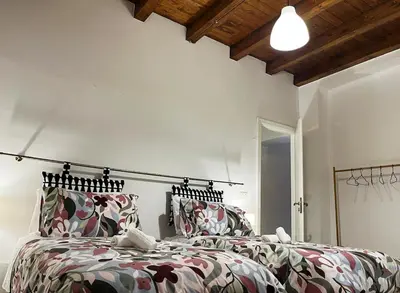 two beds in a room with white walls at Malfitano View in Palermo