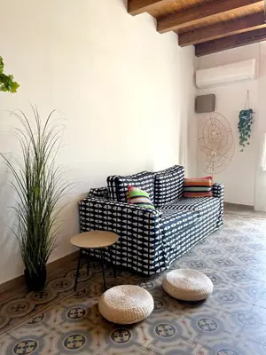 a living room with a couch and a table at Malfitano View in Palermo