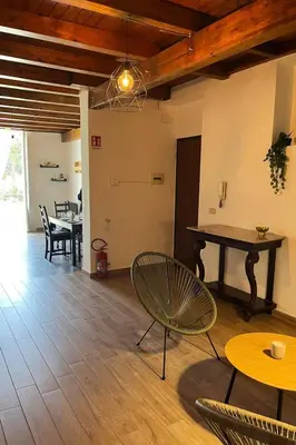 a living room with a table and chairs at Malfitano View in Palermo