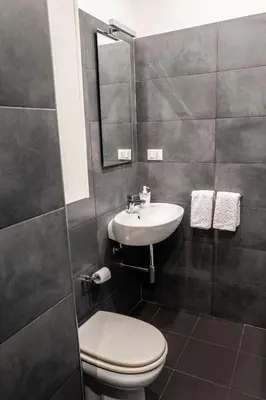 a bathroom with a toilet and a sink at Habitat in Palermo