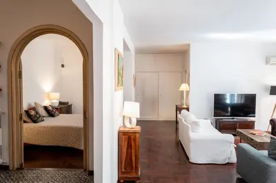 a bedroom with a bed and a living room at Habitat in Palermo