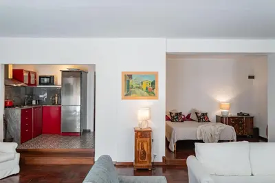 a living room with a bed and a kitchen at Habitat in Palermo