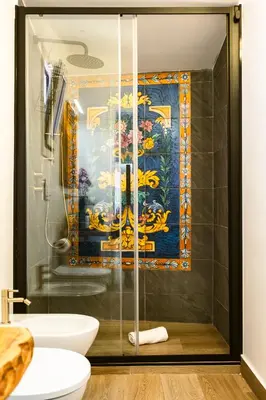 a bathroom with a shower with a painting on the wall at Royal House Palermo in Palermo