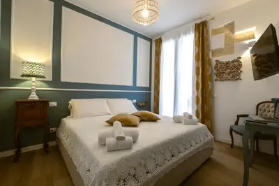 a bedroom with a bed with towels on it at Royal House Palermo in Palermo