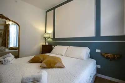 a bedroom with a bed with a mirror on the wall at Royal House Palermo in Palermo