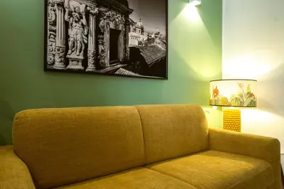 a living room with a couch and a picture on the wall at Royal House Palermo in Palermo