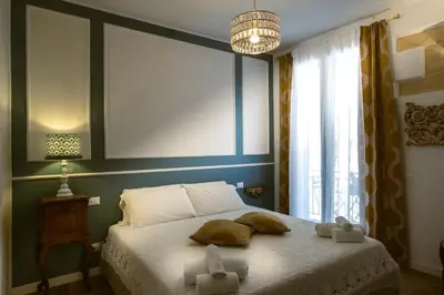 a bedroom with a bed with two towels on it at Royal House Palermo in Palermo