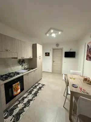 a kitchen with a stove and a table and a dining room at A Little Modern House in Palermo