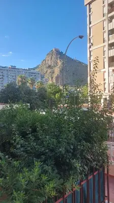 a view of a mountain from between two buildings at L'ulivo-casa tua a Palermo, a due passi dal centro in Palermo