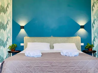 two towels on a bed with a blue wall at La casa di Didì in Palermo