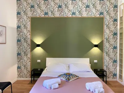 a bedroom with a bed with two towels on it at La casa di Didì in Palermo