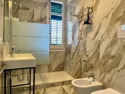 a bathroom with a sink and a toilet at La casa di Didì in Palermo