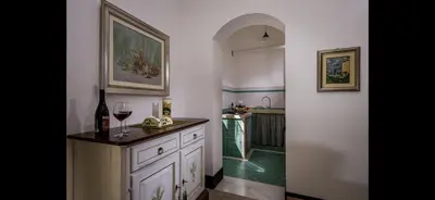 a kitchen with a sink and a counter with wine glasses at Borgo la Madrice in Castellammare del Golfo