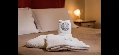 a towel sitting on top of a bed at Borgo la Madrice in Castellammare del Golfo