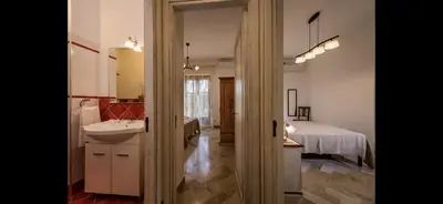 a bathroom with a sink and a bed at Borgo la Madrice in Castellammare del Golfo