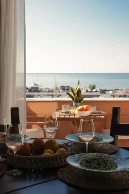 a table with plates of food and glasses of wine at Almarìa - Le case del Castello - San Nicola L'Arena - Trabia in Trabia