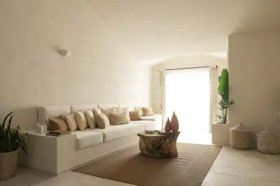 a white living room with a white couch and a window at Almarìa - Le case del Castello - San Nicola L'Arena - Trabia in Trabia
