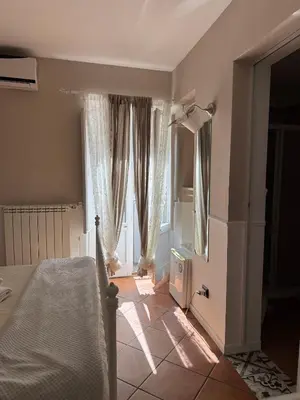 a bedroom with a bed and a large window at Dimora San Domenico in Palermo