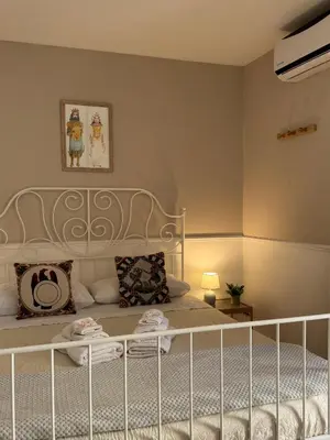 a bedroom with a bed with a white headboard at Dimora San Domenico in Palermo