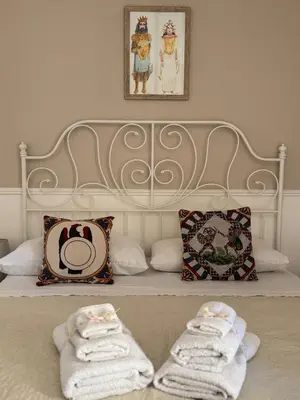 a bedroom with a bed with towels on it at Dimora San Domenico in Palermo