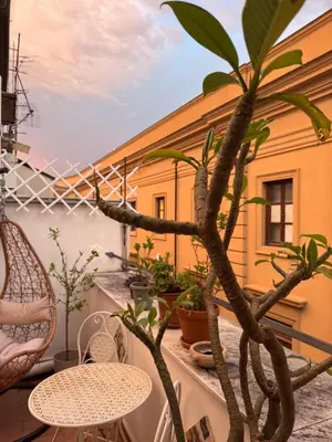 a balcony with a table and a plant at Dimora San Domenico in Palermo