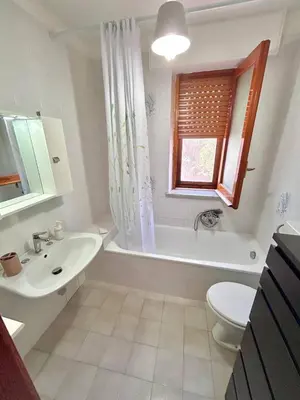 a bathroom with a sink and a tub and a toilet at Villa Gargaf in Altavilla Milicia
