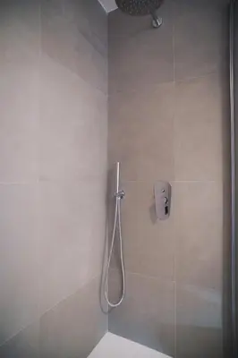 a shower with a shower head in a bathroom at Encanto Apartment in Palermo