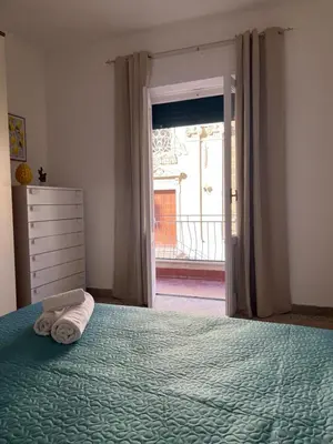 a bedroom with a bed with a towel on it at Home Sampolo in Palermo