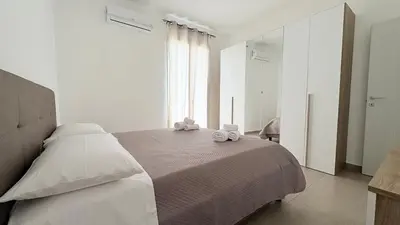 a bedroom with a bed with two towels on it at Appartamento La Duchessa in Campofelice di Roccella