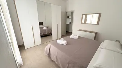 a bedroom with a bed with two towels on it at Appartamento La Duchessa in Campofelice di Roccella