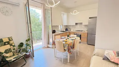 a kitchen and dining room with a table and chairs at Appartamento La Duchessa in Campofelice di Roccella