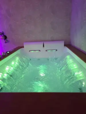 a bath tub filled with green water in a room at Thaleia Suite & Spa in Palermo
