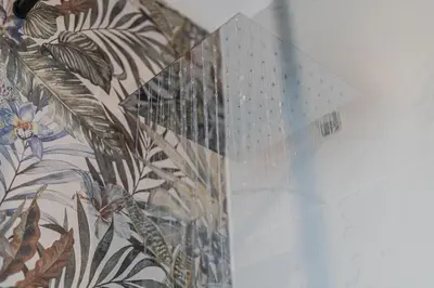 a glass wall with a floral pattern on a wall at NAHIA Collection Villa in Campofelice di Roccella