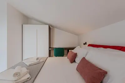 a bedroom with a large white bed and a window at NAHIA Collection Villa in Campofelice di Roccella