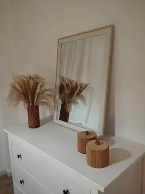 a white dresser with a mirror and two plants on it at Mammì in Balestrate