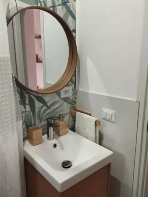 a bathroom with a white sink and a mirror at Mammì in Balestrate