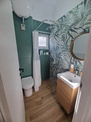 a bathroom with a white toilet and a sink at Mammì in Balestrate