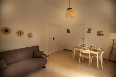 a living room with a couch and a table at Casa Alagna - La Casetta al Mare con Idromassaggio in Palermo