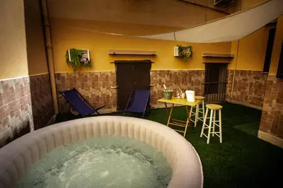 a hot tub in a room with a table and chairs at Casa Alagna - La Casetta al Mare con Idromassaggio in Palermo