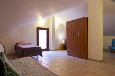a bedroom with a bed and a dresser in a room at Casa Vacanze Soleado house Trabia PA, Sicily in Mandra Capreria